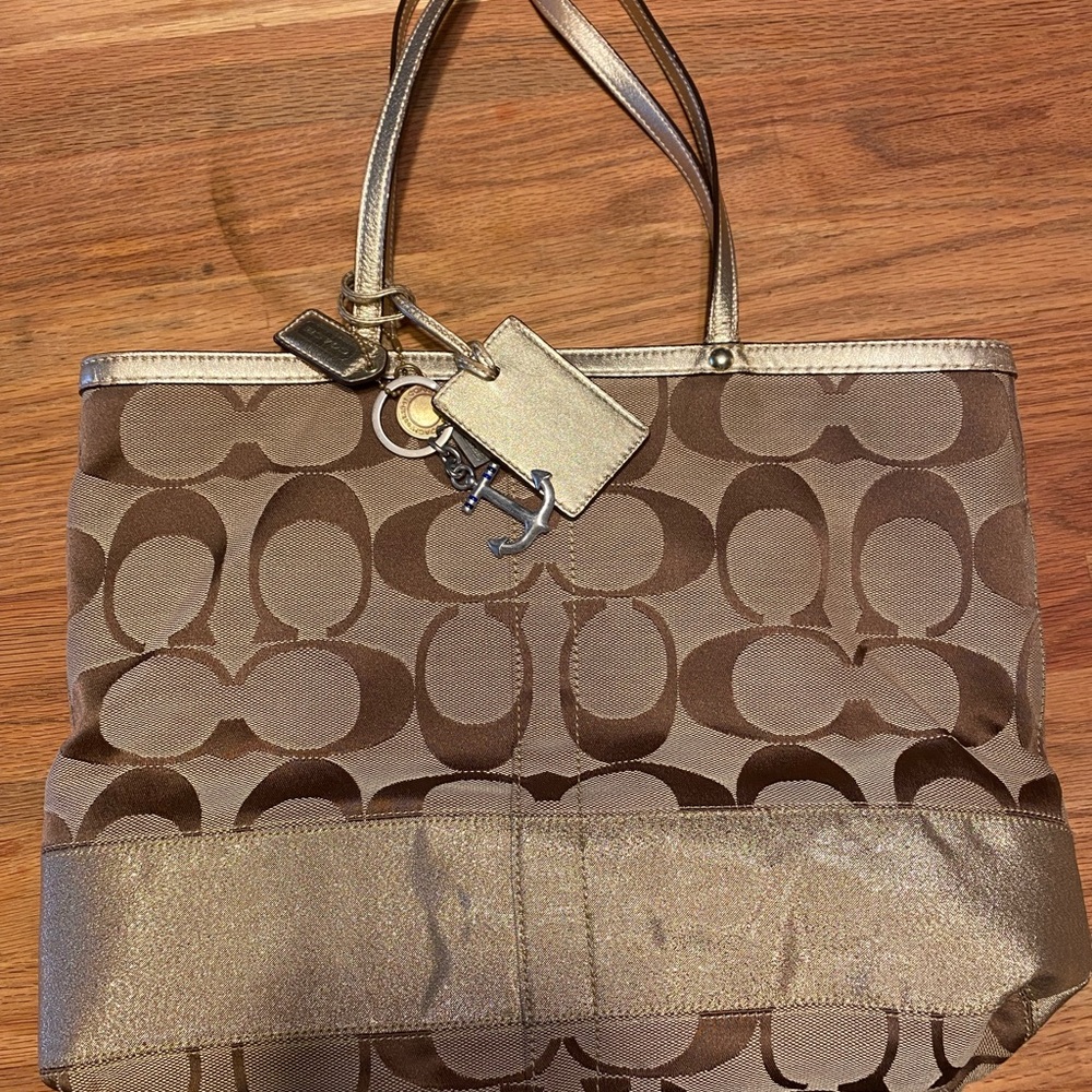 Gold coach bag with Coach anchor charm